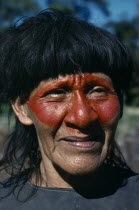 Portrait of Auca Indian with red face paint from achole plant.