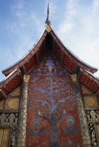 Wat Xieng Thong.  Ornate temple exterior with Tree of Life mosaic and gold decoration.
