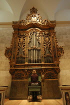 17th century baroque organ  displayed at Memorial Art Gallery  being played .American North America United States of America