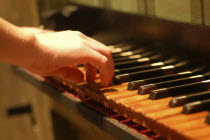 17th century baroque organ  original keyboard being played with worn keys  bass wood  at Memorial Art Gallery.American North America United States of America