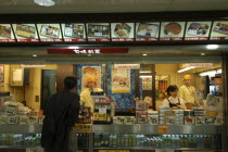 Tokyo Station  a boxed lunch  sushi stand  bento. Man ordering from counter staff.fast food Asia Asian Japanese Nihon Nippon Male Men Guy