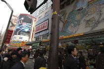 A busy street scene in the electronics city  advertising on buildings above shops.Asia Asian Japanese Nihon Nippon