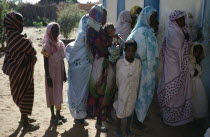 Chadian refugee women and children forming queue outside Islamic African Relief Agency clinic.Female Woman Girl Lady Kids North Africa Sudanese