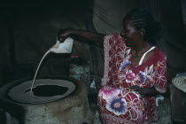 Ethiopian refugee woman making Sudanese flat bread or Kisra.Africa African Female Women Girl Lady North Africa