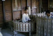 Musician playing Pat Waing drum circle.Man Asian Burma Burmese Myanma Southeast Asia