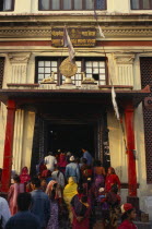 Buddhist pilgrims at temple stupa entrance.Asia Asian Nepalese Religion Religion Religious Buddhism Buddhists