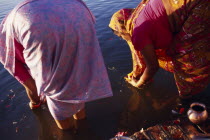 Two women making morning puja at Ganga Sagar.offering prayers Asia Asian Female Woman Girl Lady Nepalese Religion Religious 2 Female Women Girl Lady