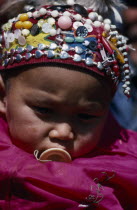 Portrait of Kazakh baby wearing hat covered with silver beads and coloured buttons.Asia Asian Babies Chinese Chungkuo Immature Jhonggu Kids One individual Solo Lone Solitary Zhonggu 1 Colored Singl...