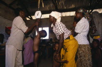 Children being weighed in mobile clinic.health worker  African Cell Cellular Eastern Africa Kenyan Kids