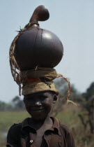 Portrait of Hutu child carrying water pot on head.African Burundian Children Eastern Africa Kids One individual Solo Lone Solitary Religion Religious Uburundi 1 Single unitary