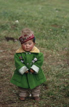 Portrait of young Kazakh child wearing green wool coat and embroidered cap.Asia Asian Children Chinese Chungkuo Immature Jhonggu Kids One individual Solo Lone Solitary Religious Zhonggu 1 Religion...