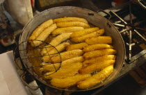 Fried bananas for sale on market stall.