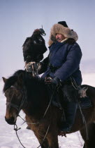 Kazakh horseman with hunting eagle on his hand. Asia Asian Chinese Chungkuo Jhonggu One individual Solo Lone Solitary Zhonggu 1 Single unitary