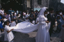 Wedding party outside church with bride and groom  bridesmaid and page boy in foreground.Mixquic American Hispanic Kids Latin America Latino Marriage Mexican Religion Religious