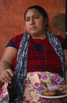 Matriarchal society.  Portrait of seated women holding bottle and plate of food.American Female Woman Girl Lady Hispanic Latin America Latino Mexican One individual Solo Lone Solitary 1 Female Women...