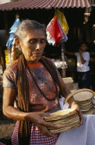 Woman selling tortillas at market.American Female Women Girl Lady Hispanic Latin America Latino Mexican One individual Solo Lone Solitary 1 Female Woman Girl Lady Single unitary