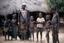 Village queen standing with group of children.  She is believed to be a witch and endowed with healing and other spiritual powers.superstition African Kids Religion Senegalese Religious