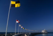 Jumeirah Beach.  Curving marina wall and line of flags.Beaches Dubayy Resort Sand Sandy Seaside Shore Tourism United Arab Emirates Al-Imarat Al-Arabiyyah Al-Muttahidah Arabic Dubai Emiriti Middle Eas...