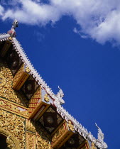 Detail of highly decorated temple roof with painted carvings of naga water serpents on diagonal.Asian Prathet Thai Raja Anachakra Thai Religion Religious Siam Southeast Asia Siamese