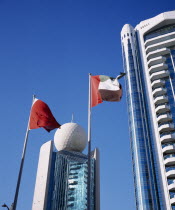 Etisalat Building on Dubai Creek with flag poles in foreground.Dubayy United Arab Emirates Al-Imarat Al-Arabiyyah Al-Muttahidah Arabic Emiriti Middle East