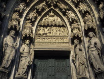 Cathedral doorway flanked by stone statues and decorative carvingsKolner DomUNESCO World Heritage SiteDeutschland Western Europe European Religious Religion