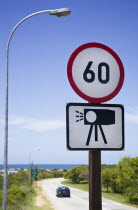 Road sign showing speed limit and warning of radar cameras.