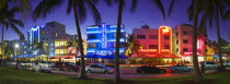 Panoramic view of the Art Deco hotels illuminated at night on Ocean Boulevard.