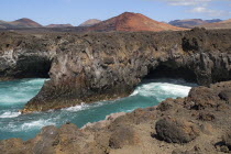 Los Hervideros or Boiling Waters from viewpoint on south west coast road.  The sea crashes through lava formed tunnels  sea eroded chimneys and arches as if boiling.volcanic Espainia Espana Espanha E...