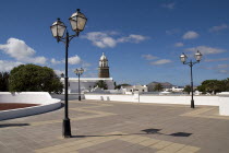 Teguise  the former capital of the island.  Large open square known as Parque le Mareta with tower of Church of Nuestra Senora de Guadalupe s and street lamps.Espainia Espana Espanha Espanya European...