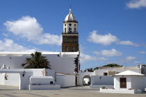 Teguise  the former capital of the island.  Church of Nuestra Senora de Guadalupe also known as Iglesia de San Miguel white painted exterior and bell tower.Espainia Espana Espanha Espanya European Hi...