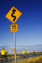 Cyclists descending from the summit of Haleakala on the longest free wheel road in the world.American North America Pacific Islands Polynesia United States of America Many Islands Polynesian Scenic...