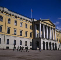 Royal Palace frontage with five guardsmen marching and sentry box