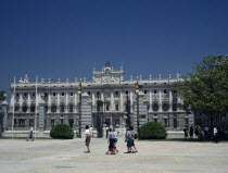 Royal Palace. Tourists in square outside railings with gates