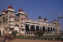Mysore Palace also known as Amba Vilas Palace completed in 1912 in Indo-Saracencic style.  Exterior with flowering bushes.