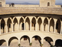 Palma.  Bellver Castle.  Cloistered circular courtyard of keep and people viewing