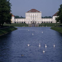 Schloss Nymphenburg. Viewed from tree lined canal with swans and ducks