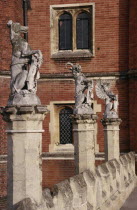 Hampton Court Palace.  Detail of west facade with line of statues of heraldic beasts.