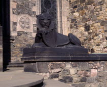 Holyrood House. Stone statue of lion holding shield next to steps