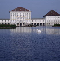 Schloss Nymphenburg. Viewed across canal with reflection and swan on water