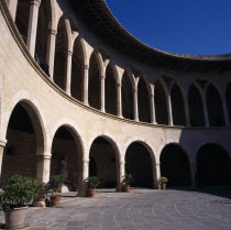 Palma. Empty Bellver Castle inner courtyard with arches and statue