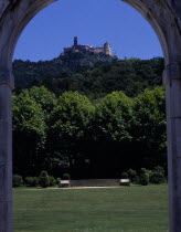 Pena Palace seen in the distance through an arch in the gardens of Seteais Palace