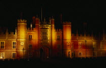 View of exterior facade illuminated at night.