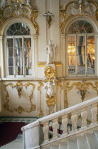 The Winter Palace of the Hermitage Museum.  Interior with detail of  the Jordan Staircase and walls with gold leaf and plaster motifs reflected in arched mirrors.