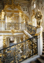 Great Palace.  Interior  detail of the main staircase and ornate  gold and white baroque decorative style.