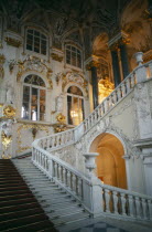 The Winter Palace of the Hermitage Museum.  Detail of the Jordan Staircase and opulent white and gold interior decoration.