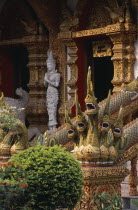 Wat Bupparam Temple on Tha Phae Road. Temple exterior with elaborate dragon stairway banisters and statue near doorway.Asian Bupharam Prathet Thai Raja Anachakra Thai Religion Siam Southeast Asia Rel...