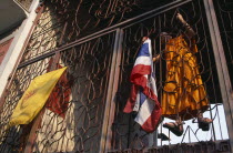 Wat Saen Fang.  Metalwork partition with monk climbing inside to attach flags.Asian Prathet Thai Raja Anachakra Thai Religion Siam Southeast Asia Religious Siamese