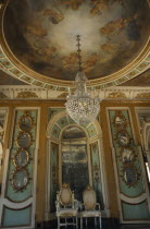 Palacio Nacional de Queluz interior. Sala dos Exbaixadores with throne chairs and detail of hanging chandelier and ceiling frescos.