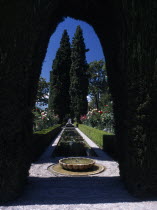 The Alhambra. Generalife Gardens with rectangular pond lined with roses and framed by arched hedge