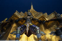 Grand Palace. Demon statue at the base of a spire or prang.